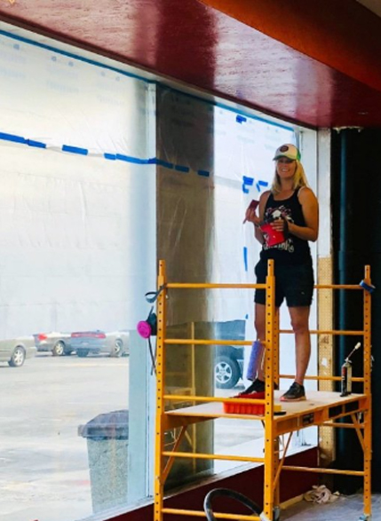 Coach Andrea Warner doing some painting on Gracie Barra Salt Lake City's construction
